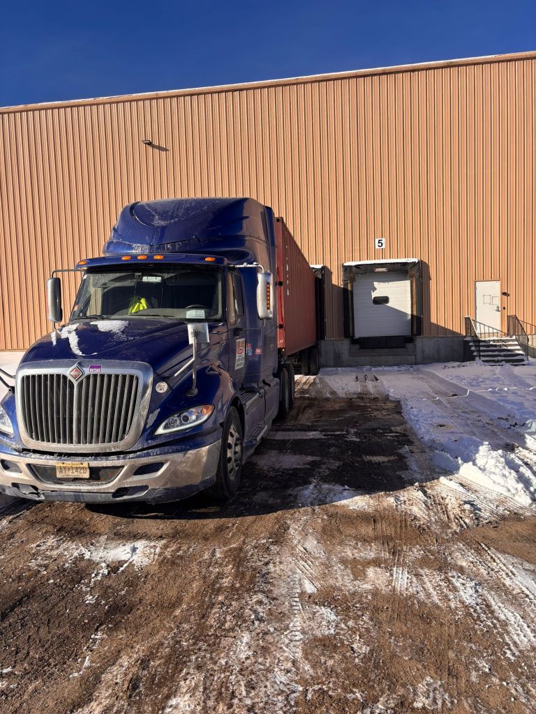 comex logistics drayage truck at customers warehouse in new york delivering a 40ft container of fitness equipment